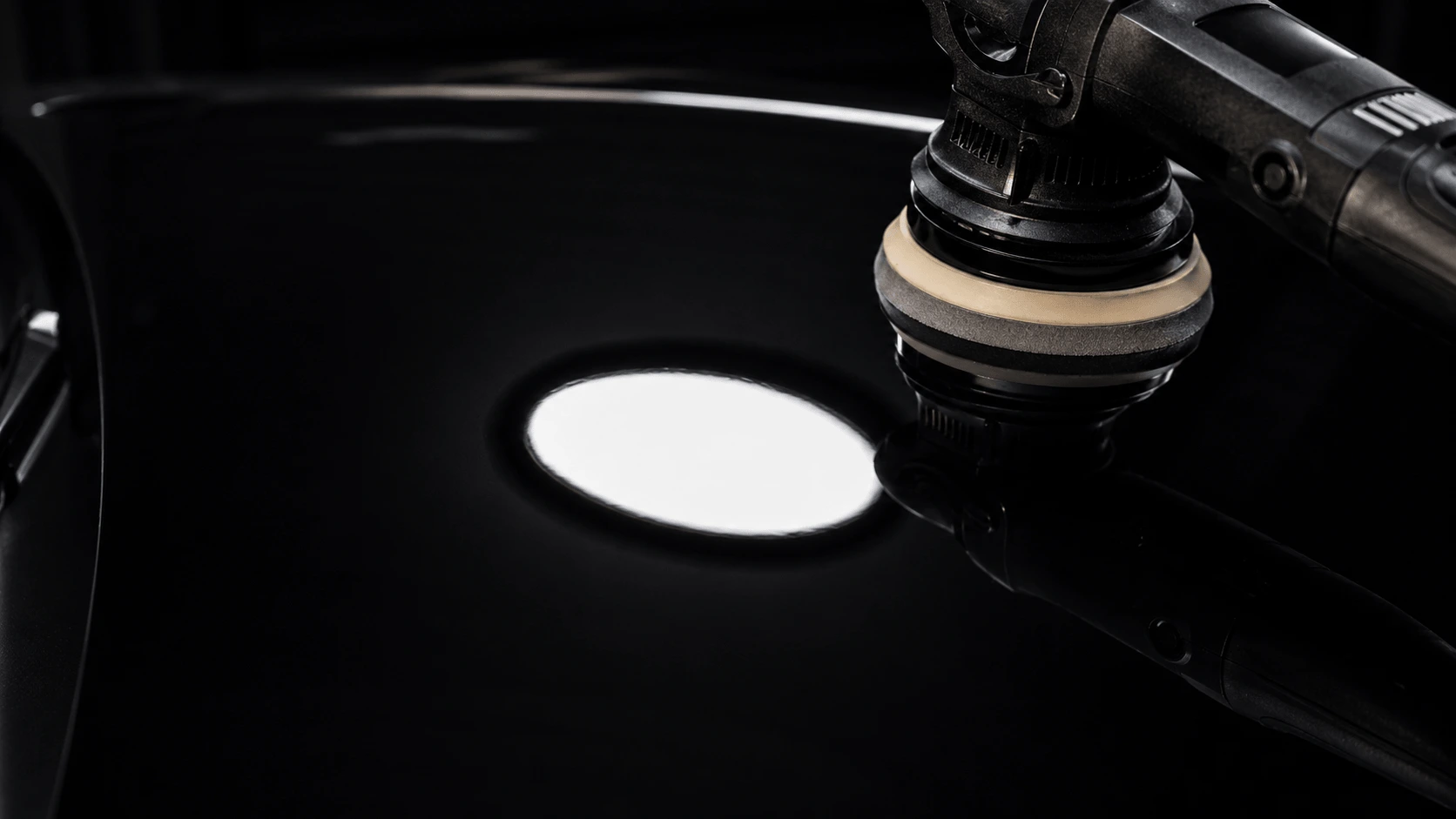 Professional orbital polisher on mirror-finish black paint — car detailing Nairobi